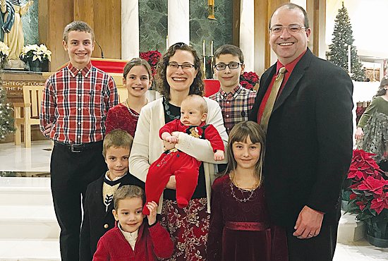 John and Heidi Flanagan, gathered here with their family at St. Joseph in West St. Paul, find opportunities to teach their seven children about life and death during regular family conversations involving faith.