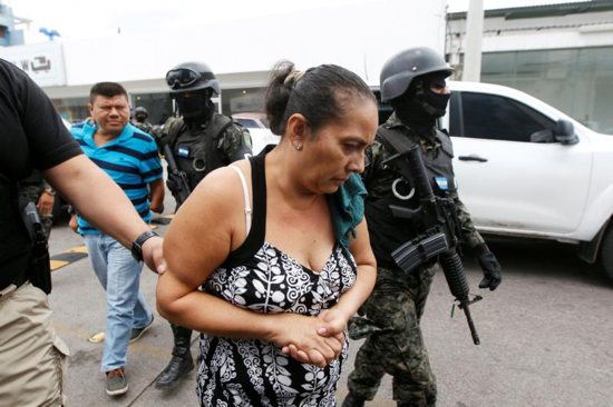 Investigative police agents escort suspected members of a human trafficking ring as they arrive to a court hearing in Tegucigalpa, Honduras, June 9, 2016.