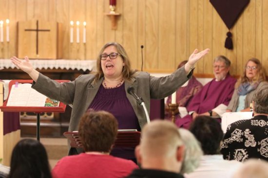 Carol Fiel directs the choir and urges the congregation to join in during Mass in 2017 at St. John the Baptist Mission in Clatskanie, Oregon. Portland Archbishop Alexander K. Sample issued a new pastoral letter calling for sacred music characterized by sanctity, beauty and universality. "Only music which possesses all three of these qualities is worthy of the holy Mass," he wrote. 