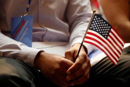 A new citizen holds a flag at the U.S. Citizenship and Immigration Services naturalization ceremony in the Manhattan borough of New York City July 3, 2018. The Supreme Court agreed Feb. 15, 2019, to hear oral arguments in April about the Trump administration's push to add a citizenship question to the 2020 census.