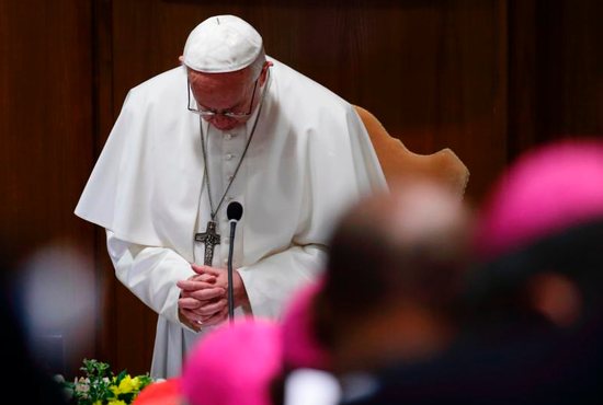 Pope Francis prays during the opening session of the meeting on the protection of minors in the church at the Vatican Feb. 21, 2019. 