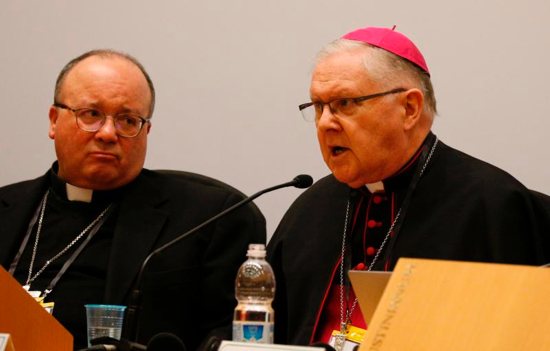 Archbishop Charles Scicluna of Malta and Archbishop Mark Coleridge of Brisbane, president of the Australian bishops' conference, attend a press briefing after the opening session of the meeting on the protection of minors in the church at the Vatican Feb. 21, 2019.