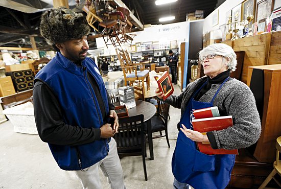 From left, Wayne Bugg and Francesca DiPiazza, a member of the Basilica of St. Mary in Minneapolis, talk about inventory at the St. Vincent de Paul thrift store in Minneapolis. He is the associate director of the Society of St. Vincent de Paul-Twin Cities and manager of the thrift store. She is the custodian of books. 