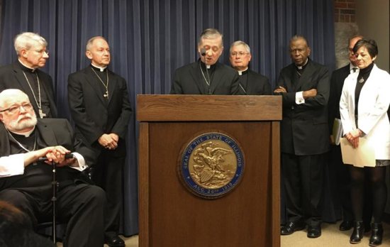 Chicago Cardinal Blase J. Cupich speaks during a March 28, 2019, news conference at the Illinois Capitol in Springfield about legislation to expand abortion and eliminate a parental notification law. He is surrounded by other Illinois bishops, left to right, Bishops Daniel R. Jenky of Peoria, R. Daniel Conlon of Joliet, Thomas J. Paprocki of Springfield, David J. Malloy of Rockford and Edward K. Braxton of Belleville.