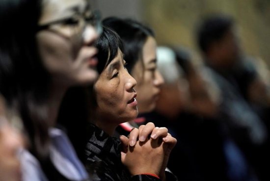 The faithful attend Mass at Beijing's South Catholic Church Sept. 29, 2018. In a new book, the Vatican secretary of state, Cardinal Pietro Parolin, writes that the Vatican's recent agreement with the Chinese government was motivated by a desire to spread the Gospel and assure freedom of the church. 