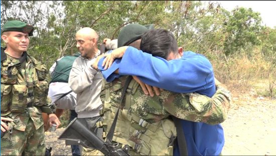 Pvt. Andry Rosales hugs a Colombian soldier after defecting from Venezuela Feb. 27, 2019. Rosales snuck out of an army base and crossed into Colombia in civilian clothes.