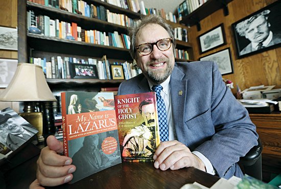 Dale Ahlquist holds his two recently published books, “My Name is Lazarus” and “Knight of the Holy Ghost.”
