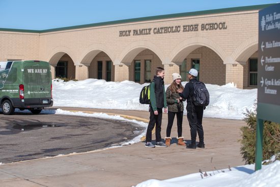 From left, freshmen Lucas Schoenecker and Laura Theis talk March 11 with sophomore Daniel Borbonio outside Holy Family Catholic High School in Victoria. All three live in Shakopee and benefit from Holy Family’s efforts to boost enrollment by busing students into the school from beyond the school’s usual Chaska-Chanhassen area. 