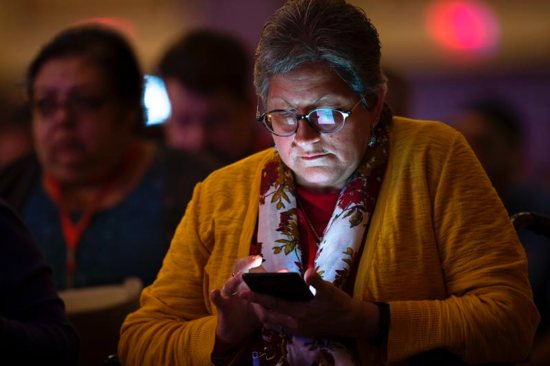 A delegate at the Fifth National Encuentro in Grapevine, Texas, checks the internet Sept. 21, 2018. Massgoers in Ireland are being urged to switch off their mobile phones during Lent.