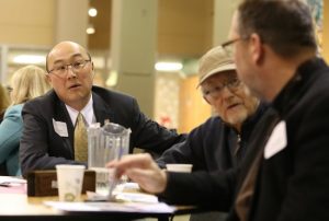 Ramsey County Attorney John Choi, left, talks Feb. 1 at St. Odilia Parish in Shoreview with Father Dan Griffith, foreground, pastor of Our Lady of Lourdes in Minneapolis, and Mark Umbreit, center, director of the Center for Restorative Justice and Peacemaking at the University of Minnesota in St. Paul.
