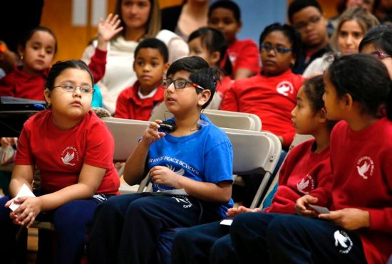 Students at Children of Peace Catholic School in Chicago use sign language Feb. 22, 2019, to respond to actress Lauren Teruel Ridloff, a Tony Award nominee and currently a star of "The Walking Dead" series on AMC. Ridloff, who is deaf, graduated from in 1991 from the school, which at that time was called Holy Trinity School for the Deaf.