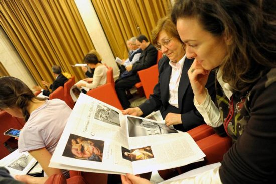 Women look at "Women-Church-World," a monthly women's magazine insert in the Vatican's L'Osservatore Romano newspaper, in this file photo. Claiming a lack of support for open dialogue and for an editorial line run by women, the director and editorial staff of the magazine insert have resigned. 