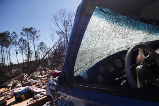 A car and house are seen in Beauregard, Ala., March 5, 2019, after tornadoes ran through the area. Mobile Archbishop Thomas J. Rodi asked for prayers for "those who lost their lives and their loved ones as well as those who have lost homes and businesses."