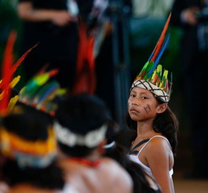 A young member of an indigenous group from the Amazon region listens during a meeting with Pope Francis Jan. 19, 2018, at Madre de Dios stadium in Puerto Maldonado, Peru. The president of the Latin America Jesuit Conference said without the Amazon, "we all go under."