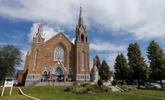 Worshippers leave Sainte-Agnes Church in Lac Megantic, Quebec, following Mass July 14, 2013. A third of Canada's Christian architecture, some 9,000 churches, will close in the next 10 years, according to the National Trust for Canada. 