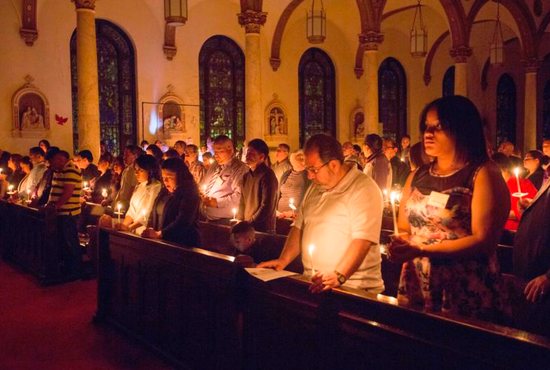 Catechumens and others attend the Easter Vigil Mass in 2016 at St. Paul Church in Wilmington, Del. The U.S. church welcomes thousands of new Catholics at Easter Vigil Masses March 31.