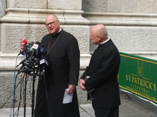 New York Cardinal Timothy M. Dolan speaks to the media outside St. Patrick's Cathedral during a news conference following the devastating fire at Notre Dame Cathedral in Paris April 15, 2019. At right is Msgr. Robert Ritchie, rector of St. Patrick's. 