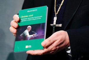 Cardinal Lorenzo Baldisseri, secretary-general of the Synod of Bishops, holds Pope Francis' apostolic exhortation, "Christus Vivit" (Christ Lives), during a news conference for its presentation at the Vatican April 2, 2019. The document contains the pope's reflections on the 2018 Synod of Bishops on young people, the faith and vocational discernment. 