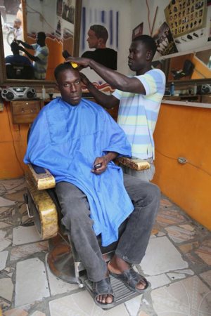 A barber cuts a man's hair at his shop in Hinche, Haiti, Feb. 13, 2015. Christian hairdressers, beauticians and barbers can live their faith by being kind and courteous to their clients and cutting out the gossip and petty chitchat, Pope Francis said.