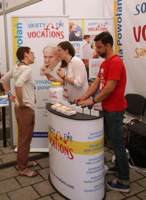 A woman talks with a pilgrim at the World Youth Day evangelization center in Krakow, Poland, in this July 29, 2016, file photo. In a newly released document, Pope Francis said that to discern a vocation, people have to realize it's a calling from a friend, Jesus. The document, "Christus Vivit" ("Christ Lives"), was the pope's reflection on the Synod of Bishops on young people, the faith and vocational discernment. 