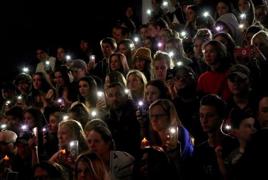People hold up lights from their cellphones during a vigil May 8, 2019, for victims of a shooting at the STEM School Highlands Ranch in Colorado. Catholic leaders are calling for prayer and action in response to the May 7 shooting inside the charter school near Denver that focuses on science, technology, engineering and math. Kendrick Castillo, an 18-year-old Catholic senior was killed when he "lunged" at one of the shooters to save others. Eight other students were wounded.