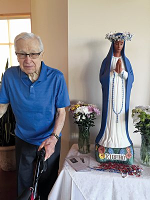Matt Wiederkehr in 2015 with a statue of Our Lady of Kibeho at St. Genevieve in Centerville.