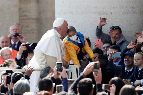 Pope Francis kisses a child during his general audience in St. Peter's Square at the Vatican May 8, 2019.