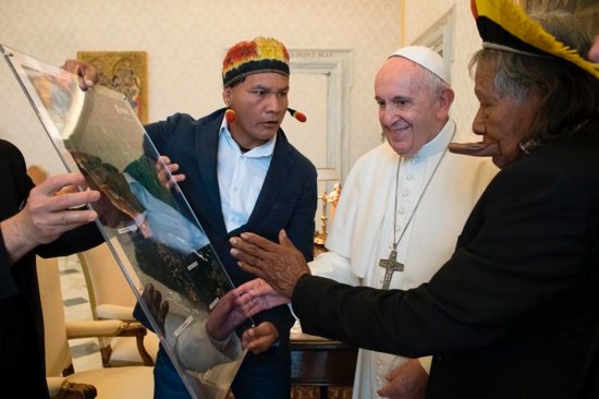 Raoni Metuktire, chief of the Kayapo indigenous group in the Brazilian Amazon region, right, shows Pope Francis a map of the Amazon rainforest during a private audience at the Vatican May 27, 2019. The indigenous chief met with the pope to discuss the Synod of Bishops on the Amazon, which will be at the Vatican in October.