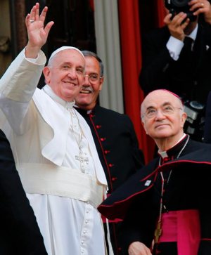 Pope Francis waves outside St. Patrick in the City Church in Washington, Sept. 24, 2015, while accompanied by Archbishop Carlo Maria Vigano, then the apostolic nuncio to the United States. In a published report May 28, 2019, Pope Francis denied Archbishop Vigano's claims that the pontiff and other church officials failed to act on accusation of abuse of conscience and power by former Cardinal Theodore McCarrick.