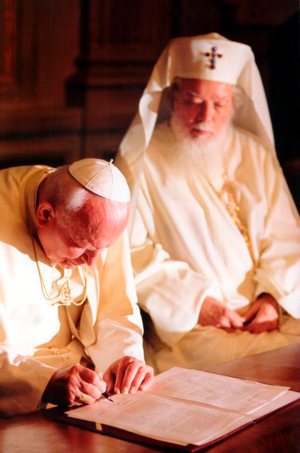Pope John Paul II and Romanian Orthodox Patriarch Teoctist sign a joint appeal for brotherhood and coexistence in the Balkans, in Bucharest, Romania, in May 1999. The trip was a significant step toward improved relations between the Orthodox majority and the Catholic minority in Romania.