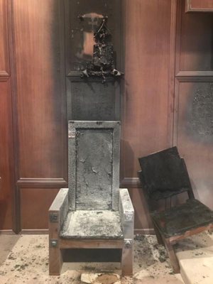 The charred remains of the cathedra, or bishop's chair, and the presider's chair in the sanctuary of the Co-Cathedral of St. Thomas More in Tallahassee, Fla