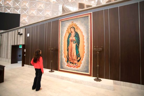 A woman looks at a large tile mosaic of Our Lady of Guadalupe June 21, 2019, in the Christ Cathedral