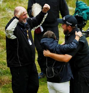 Irish golfer Shane Lowry, right, celebrates with his parents, Brendan and Bridget
