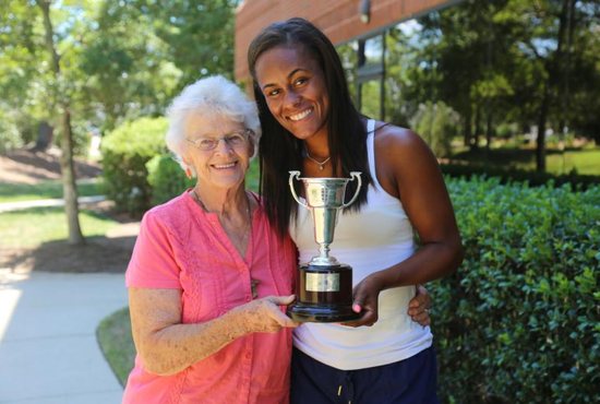Joan Monti and Abbey Forbes hold the trophy July 22, 2019, that Forbes won at Wimbledon.