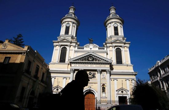 A man is silhouetted in front of St. Ignatius of Loyola Church in Santiago, Chile