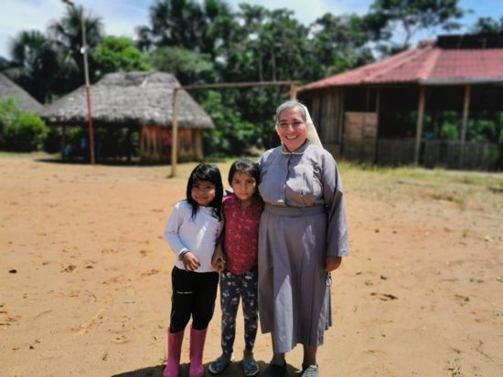 Sister Rosa Elena Pico, a member of the Missionaries of Mary Co-Redemptrix, poses for a photo with children from the indigenous community of Sarayaku, Ecuador, Sept. 18, 2019. Sr. Pico has worked and lived with the community since 2017 and occasionally leads the liturgy of the word in the absence of a priest.