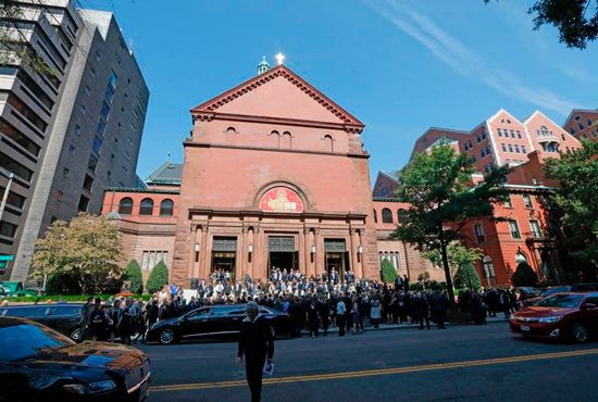Family and friends stand outside the Cathedral of St. Matthew the Apostle in Washington 