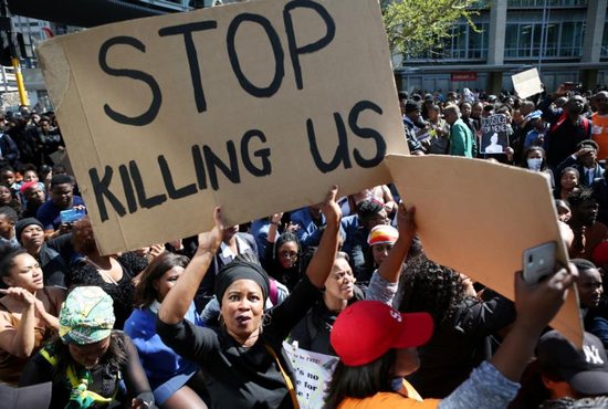 A woman holds a sign as demonstrators gather Sept. 4, 2019, at the World Economic Forum on Africa in Cape Town during a protest against gender-based violence. South African bishops called for action to end violence against women after a spate of killings and rapes sparked outrage in a country with one of the world's highest murder rates.