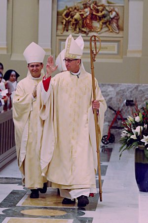 Bishop DeGrood walks with Bishop Andrew Cozzens, left, as he blesses the faithful at his ordination Mass. Behind them is Bishop Emeritus Paul Swain, who preceded Bishop-elect DeGrood as the leader of the Diocese of Sioux Falls.