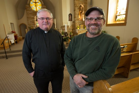 Father Michael Miller and Dan Cervenka stand inside the church of St. Patrick in Cedar Lake. Cervenka did the stone work visible in the background, and Father Miller, pastor, worked with Cervenka to build a new tabernacle base so the tabernacle could be moved to the center of the sanctuary. 