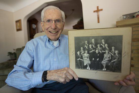 Paul Ditter holds a photo of his eighth-grade class at Holy Name of Jesus School in Medina taken in 1941