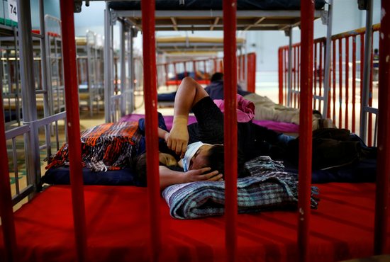 A migrant from Central America who was airlifted from Brownsville, Texas, to El Paso, Texas, and then deported with her son are seen at a temporary temporary shelter in Ciudad Juarez, Mexico, April 5, 2021. 