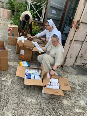 In Jacmel, Haiti, Felician Sisters Mary Inga Borko and Sister Mary Julitta Kurek pack boxes of clothing and medical supplies to send to Les Cayes Aug. 14, 2021, following the earthquake in southern Haiti. The Felician Sisters of New Jersey, who have a community in Jacmel, are organizing further relief shipments to the Les Cayes region.