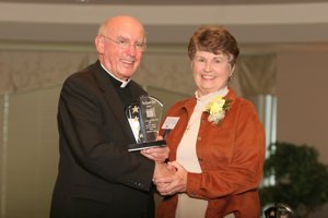 Archbishop Harry Flynn presents a Leading with Faith award to Carol Oldowski in 2007.