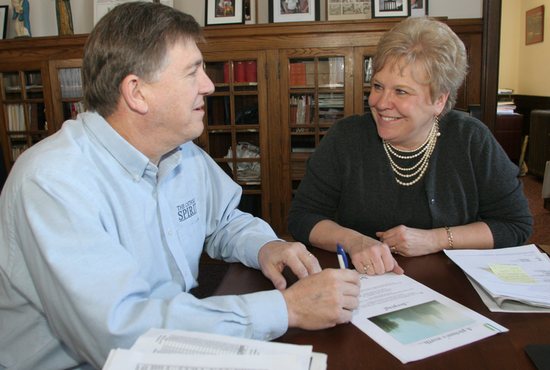 In this file photo from 2009, Bob Zyskowski, associate publisher of The Catholic Spirit, talks with Mary Gibbs, his administrative assistant. The two worked together annually to plan the Leading with. Faith awards program and luncheon.