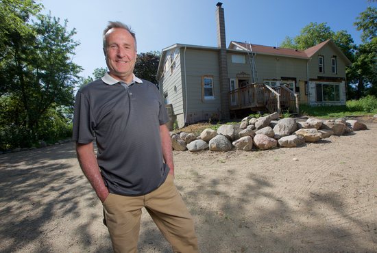 Tim Murray stands outside a farmhouse he is restoring to create a retreat center for men in recovery from addiction called St. Isidore Farm. 