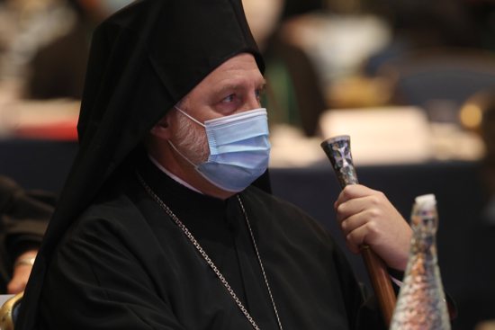 Archbishop Elpidophoros, chairman of the Assembly of Canonical Orthodox Bishops of the United States, wearing a protective mask, listens to a speaker during a Nov. 16, 2021, session of the fall general assembly of the U.S. Conference of Catholic Bishops in Baltimore. Due to the COVID-19 pandemic, it is the first in-person bishops' meeting since 2019.