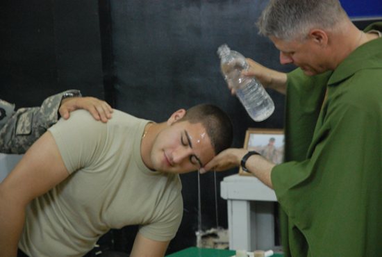 Father Eric Albertson baptizes a soldier during Operation Iraqi Freedom in this undated photo. The priest, a colonel in the Army, is the command chaplain for the U.S. Special Operations Command stationed at MacDill Air Force Base in Tampa, Fla. 