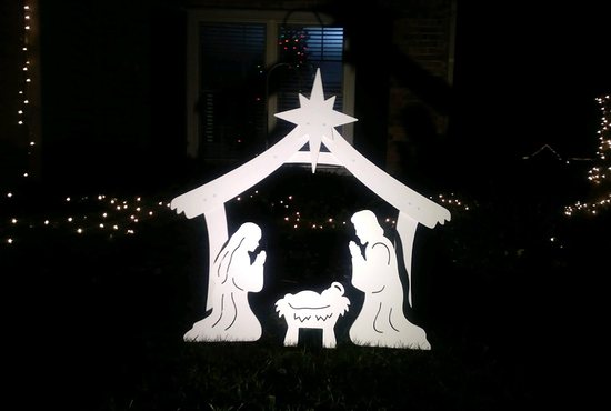 A spotlight illuminates a Nativity scene in Fishers, Ind., Dec. 3, 2021.