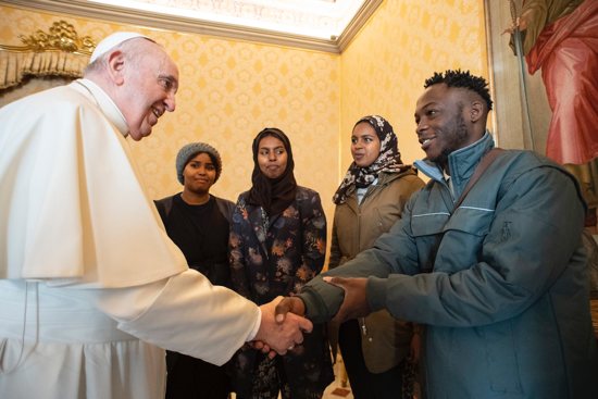 Pope Francis greets asylum-seekers transferred from Cyprus to Italy with his help, during a meeting at the Vatican Dec. 17, 2021. The migrants are being assisted by the Vatican and the Community of Sant'Egidio.